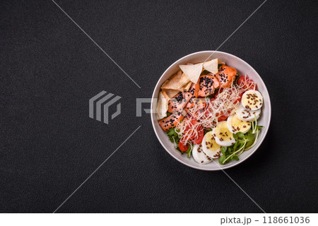 Delicious fresh caesar salad with salmon, lettuce, tomatoes and egg Delicious fresh caesar salad with salmon, lettuce, tomatoes and egg 118661036