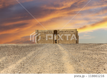 Qasr Kharana (Kharanah or Harrana)-- desert castle in eastern Jordan (100 km of Amman). Built in 8th century AD to be used as caravanserai, a resting place for traders. Against the sky with clouds Qasr Kharana (Kharanah or Harrana)-- desert castle in eastern Jordan (100 km of Amman). Built in 8th century AD to be used as caravanserai, a resting place for traders. Against the sky with clouds 118661216