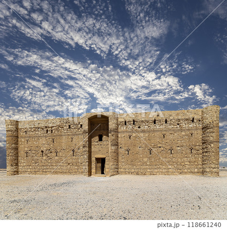 Qasr Kharana (Kharanah or Harrana)-- desert castle in eastern Jordan (100 km of Amman). Built in 8th century AD to be used as caravanserai, a resting place for traders. Against the sky with clouds 118661240