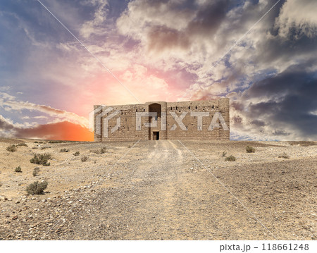 Qasr Kharana (Kharanah or Harrana)-- desert castle in eastern Jordan (100 km of Amman). Built in 8th century AD to be used as caravanserai, a resting place for traders. Against the sky with clouds Qasr Kharana (Kharanah or Harrana)-- desert castle in eastern Jordan (100 km of Amman). Built in 8th century AD to be used as caravanserai, a resting place for traders. Against the sky with clouds 118661248