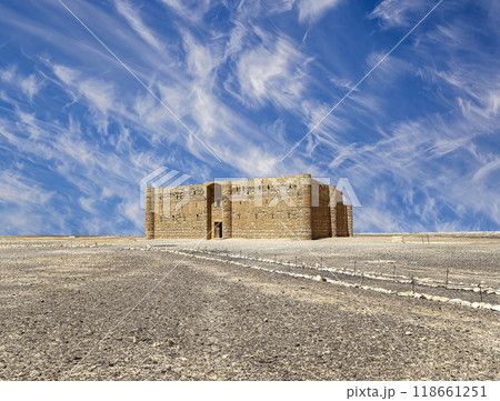 Qasr Kharana (Kharanah or Harrana)-- desert castle in eastern Jordan (100 km of Amman). Built in 8th century AD to be used as caravanserai, a resting place for traders. Against the sky with clouds Qasr Kharana (Kharanah or Harrana)-- desert castle in eastern Jordan (100 km of Amman). Built in 8th century AD to be used as caravanserai, a resting place for traders. Against the sky with clouds 118661251