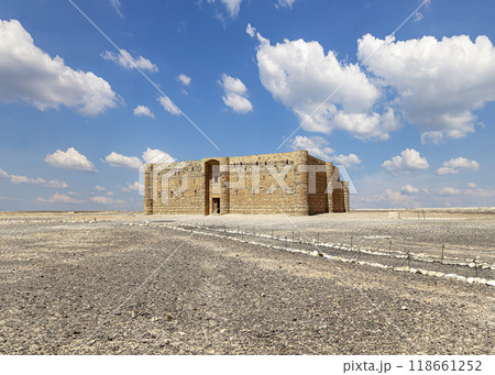 Qasr Kharana (Kharanah or Harrana)-- desert castle in eastern Jordan (100 km of Amman). Built in 8th century AD to be used as caravanserai, a resting place for traders. Against the sky with clouds 118661252