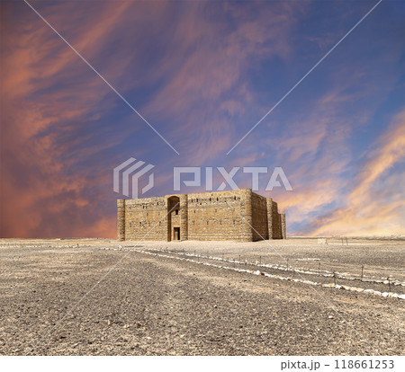 Qasr Kharana (Kharanah or Harrana)-- desert castle in eastern Jordan (100 km of Amman). Built in 8th century AD to be used as caravanserai, a resting place for traders. Against the sky with clouds 118661253