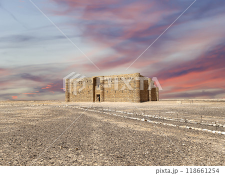 Qasr Kharana (Kharanah or Harrana)-- desert castle in eastern Jordan (100 km of Amman). Built in 8th century AD to be used as caravanserai, a resting place for traders. Against the sky with clouds 118661254