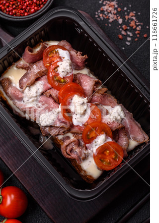 Sandwich with brioche bun, roast beef, tomatoes, stracciatello 118661726