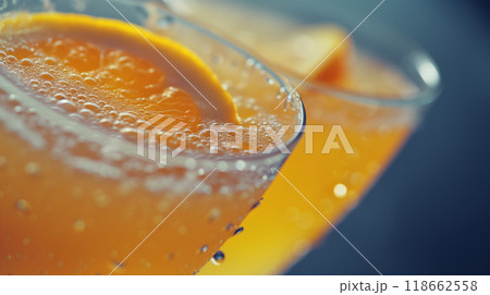 Fresh orange juice in a glass with effervescent bubbles. Fresh orange juice in a glass with effervescent bubbles. 118662558
