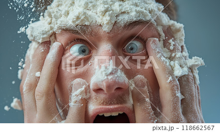 Man with face covered in flour, shocked. 118662567