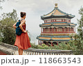 China Travel. Woman traveler relaxing enjoying travelling looking at nature view from old Chinese temple, tourist attraction in Beijing, china. Summer palace tourism destination, Asia travel 118663543