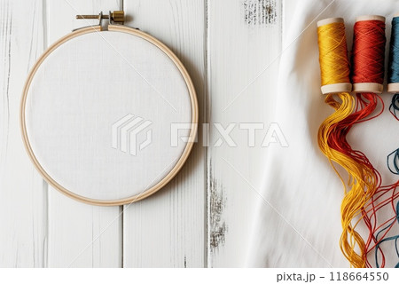 Flat lay composition with embroidery hoop and thread on white wooden background 118664550
