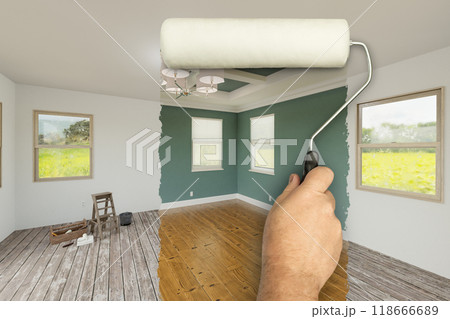 Before and After of Man Using A Paint Roller to Reveal Newly Remodeled Room with Fresh Green Paint, Coffered Ceiling and New Floors. 118666689
