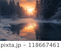 Frozen lake reflecting dramatic sunset in a snowy forest 118667461