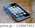 Modern smartphone getting wet from water droplets 118667462