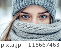 Beautiful young woman wearing knitted wool hat and scarf in winter 118667463