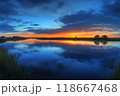 Breathtaking sunset reflecting on calm lake water in kinderdijk 118667468