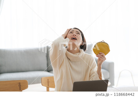 財布を持ち落ち込む女性 118668442