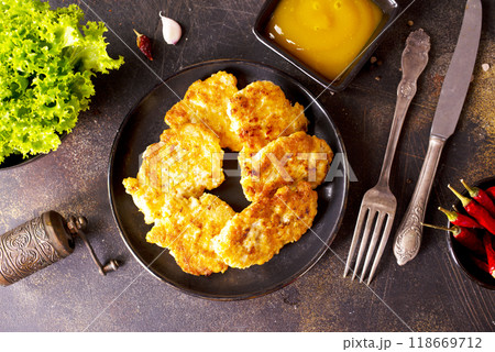 white fish cutlets on black plate 118669712