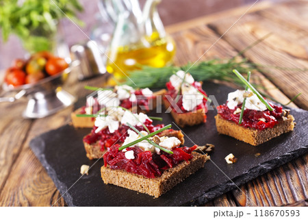 Baked beet on bread, with cheese and walnuts 118670593
