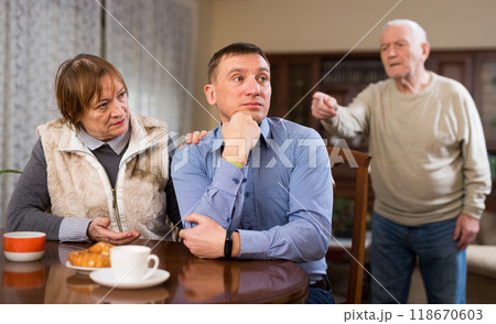 Senior man scolding his adult son Senior man scolding his adult son 118670603