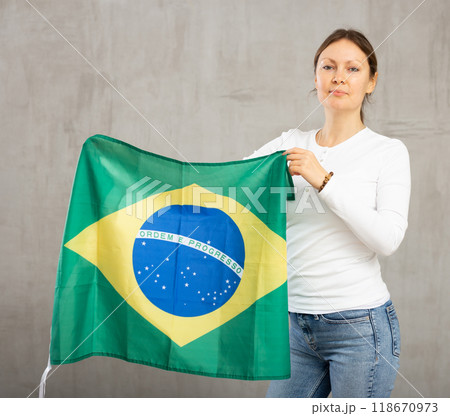 Adult cheerful woman holding Brazil flag 118670973