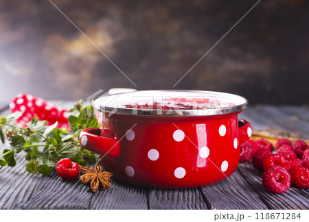 raspberry jam in red metal bowl 118671284