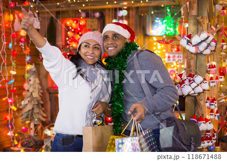 Portrait of couple points to toys at street market 118671488