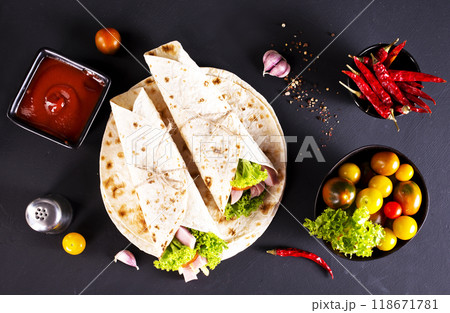 wrap sandwich with ham, lettuce, tomatoes and cheeses wrap sandwich with ham, lettuce, tomatoes and cheeses 118671781