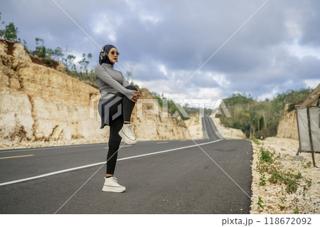 hijab woman wearing sportswear stretching before running 118672092