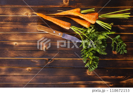 Orange and yellow carrots on a table 118672153