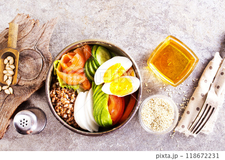 Healthy vegan nutritious bowl with buckwheat. Salad of avocado, salmon, buckwheat, egg and tomato 118672231