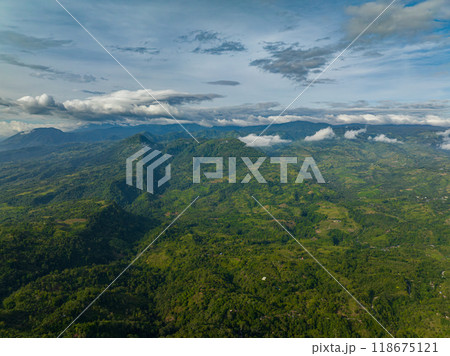 Tropical mountain valley with forest. Blue sky and clouds. Mindanao, Philippines. Tropical mountain valley with forest. Blue sky and clouds. Mindanao, Philippines. 118675121