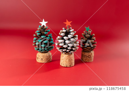 Beautiful fir tree crafted from glued pine cones, painted, with cork stopper base and cardboard star on top. Unique, handmade holiday decoration showcasing creative use of materials Beautiful fir tree crafted from glued pine cones, painted, with cork stopper base and cardboard star on top. Unique, handmade holiday decoration showcasing creative use of materials 118675458