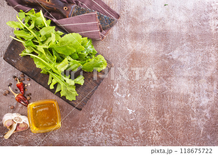 Fresh arugula leaves, rucola on wooden board Fresh arugula leaves, rucola on wooden board 118675722