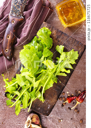 Fresh arugula leaves, rucola on wooden board Fresh arugula leaves, rucola on wooden board 118675725