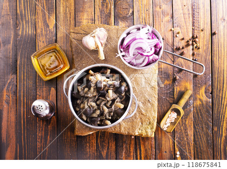 pickled mushrooms in metal bowl on the table, next to spices. pickle mushrooms 118675841