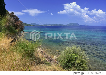 Beautiful beach with sea, sun and blue sky. Concept for travel and summer vacation. Greece-island of Corfu. Beautiful beach with sea, sun and blue sky. Concept for travel and summer vacation. Greece-island of Corfu. 118676746