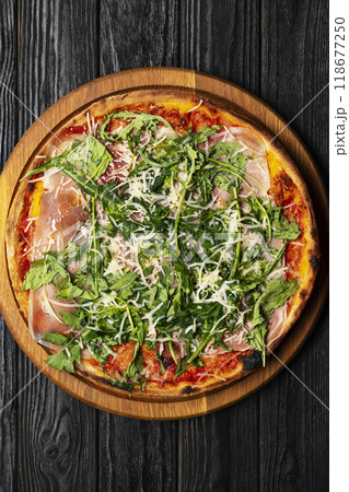 Pizza with Parma ham, arugula and parmesan Pizza with Parma ham, arugula and parmesan 118677250