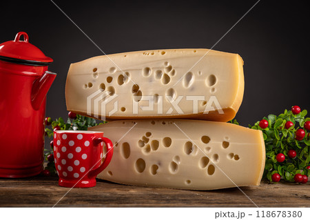 Two blocks of swiss cheese on wooden table Two blocks of swiss cheese on wooden table 118678380