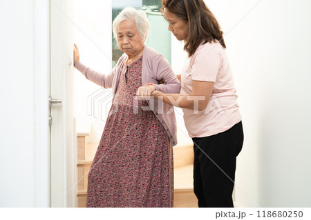 Caregiver help asian or elderly old woman support up the stairs in home. 118680250