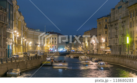 Moyka river timelapse in Saint Petersburg, Russia at night with a motion blurred touristic boat, illuminated old buildings. Moyka river timelapse in Saint Petersburg, Russia at night with a motion blurred touristic boat, illuminated old buildings. 118680283