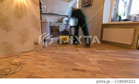 Carpenter worker cleaning room after installing wood parquet board during flooring work timelapse Carpenter worker cleaning room after installing wood parquet board during flooring work timelapse 118680322