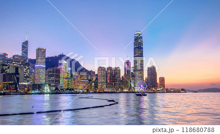 Hong Kong, China skyline panorama with skyscrapers day to night from across Victoria Harbor timelapse. 118680788