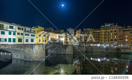 Famous Ponte Vecchio bridge timelapse hyperlapse over the Arno river in Florence, Italy, lit up at night 118680896