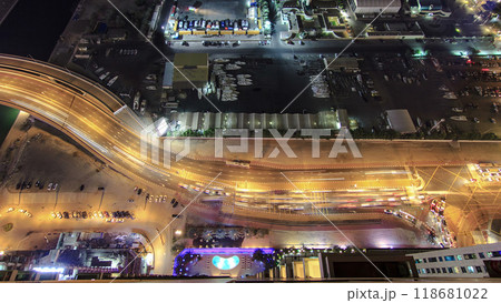 City aerial view of Dubai road with traffic from skyscraper at night timelapse 118681022