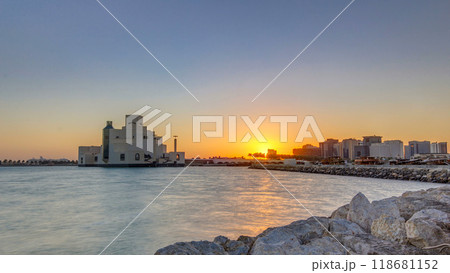 Doha Harbor with passing fishing boats during sunrise timelapse with museum of islamic art on background. Doha Harbor with passing fishing boats during sunrise timelapse with museum of islamic art on background. 118681152