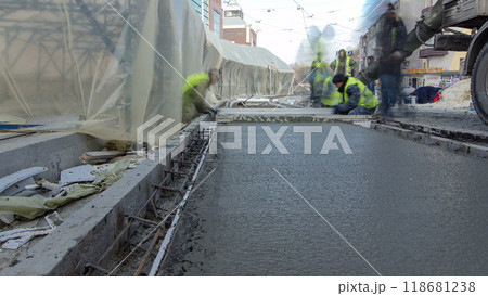 Pouring ready-mixed concrete after placing steel reinforcement to make the road by concrete mixer timelapse hyperlapse. 118681238