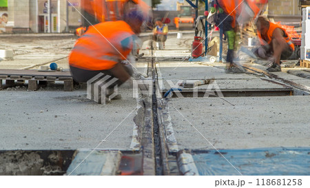 Tram rails at the stage of their installation and integration into concrete plates on the road timelapse 118681258