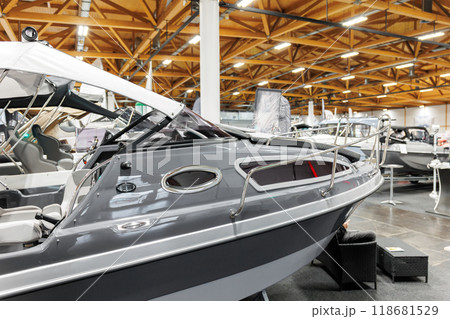 Many small big ship yachts at boat show exhibition indoors hall. Marine fishing yachting sailing vessel expo commercial trading business. Modern recreation sport water transport fair 118681529