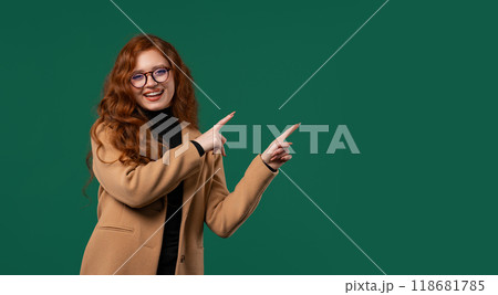 Recommending smiling BusinessWoman pointing at side copy space or advertising. 118681785