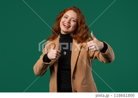 Positive businesswoman with hand sign like, thumbs up gesture. Lady on green 118681800