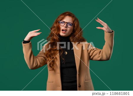 Irritated sarcastic businesswoman showing bla-bla gesture hands on green studio Irritated sarcastic businesswoman showing bla-bla gesture hands on green studio 118681801